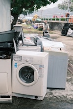 a pile of washing machines sitting next to each other