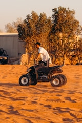 a man riding on the back of a four wheeler