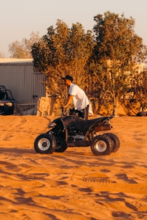 a man riding on the back of a four wheeler