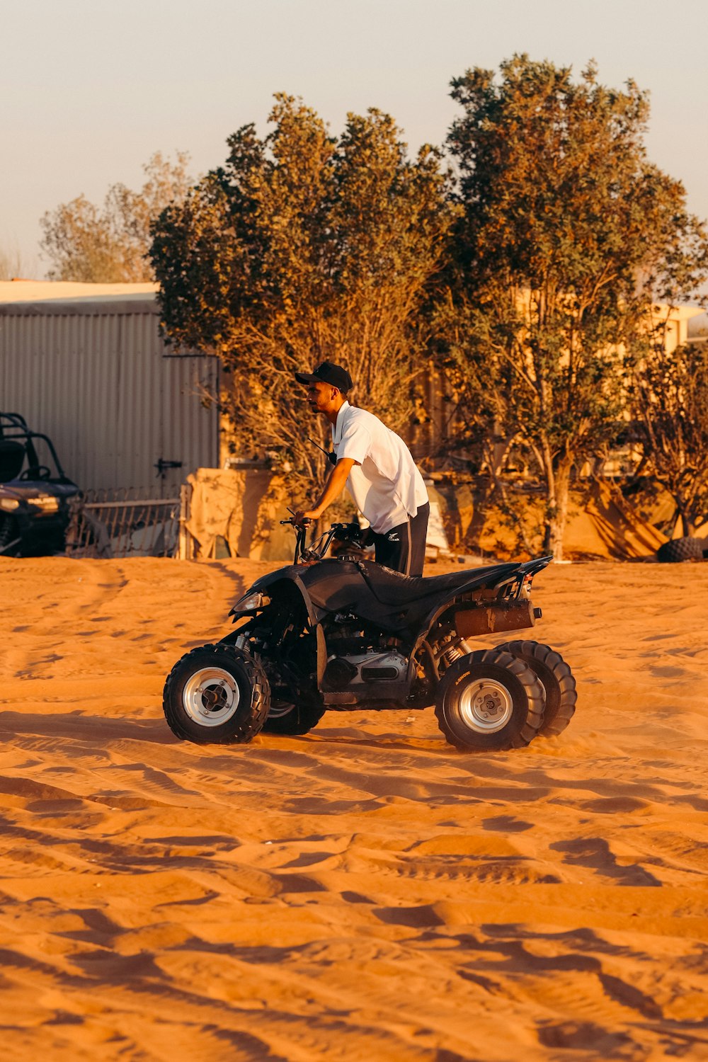 a man riding on the back of a four wheeler
