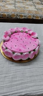 A simple yet stunning cake with a smooth pink frosting.