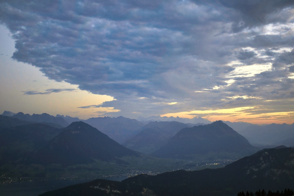 a view of a mountain range with clouds in the sky