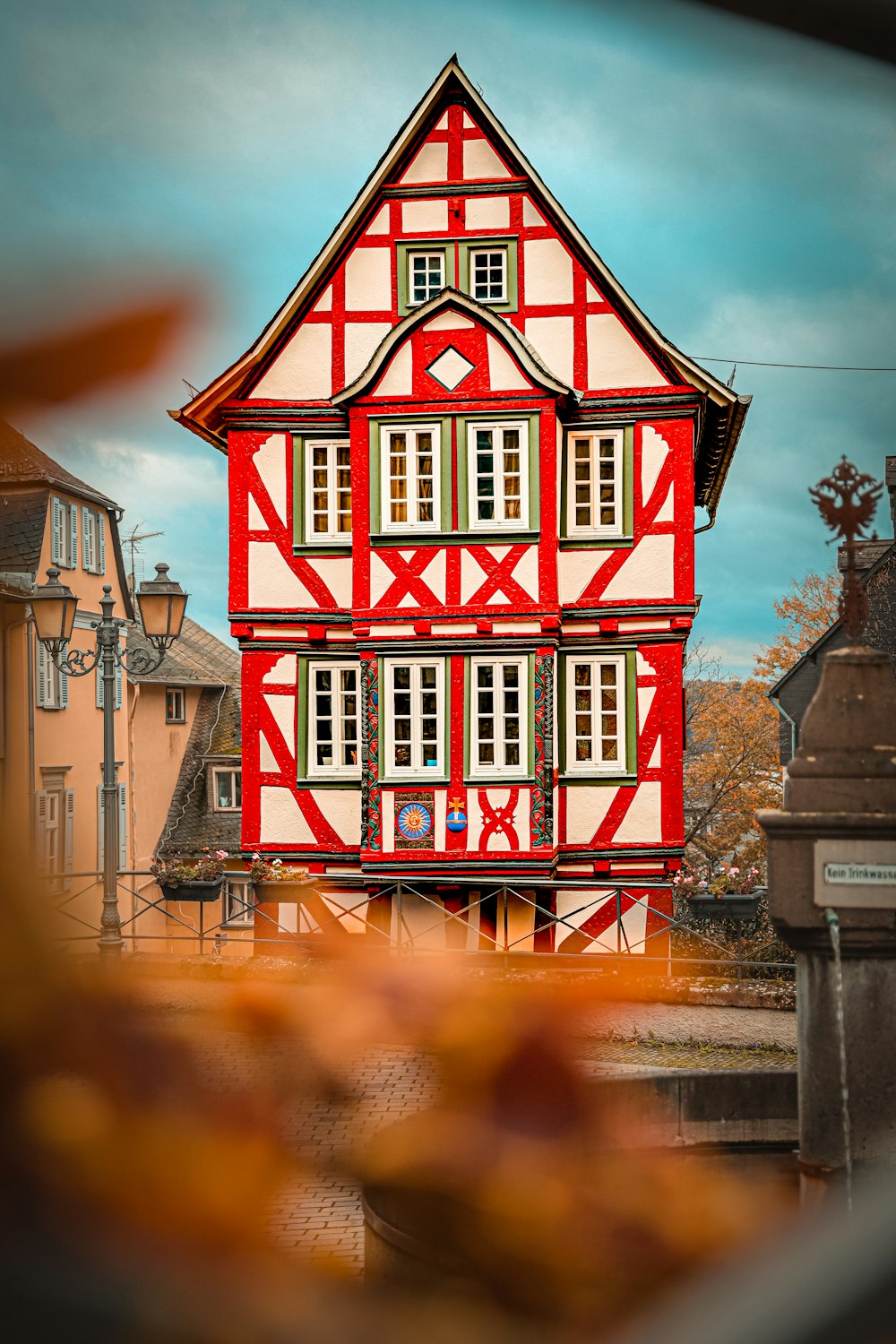 a red and white house with windows and shutters