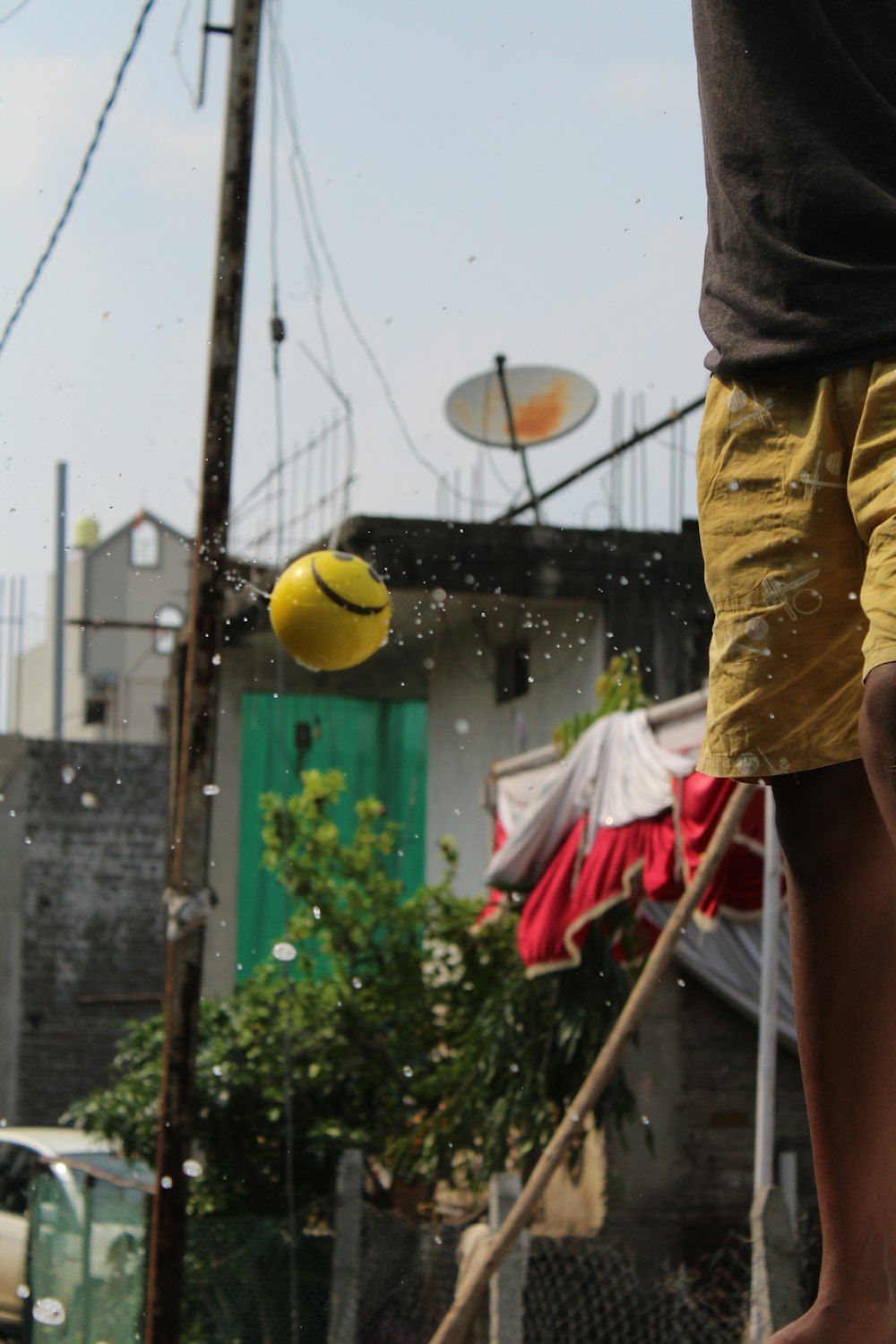 a person is playing with a yellow ball