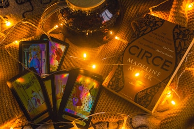 a table topped with cards and candles on top of a blanket