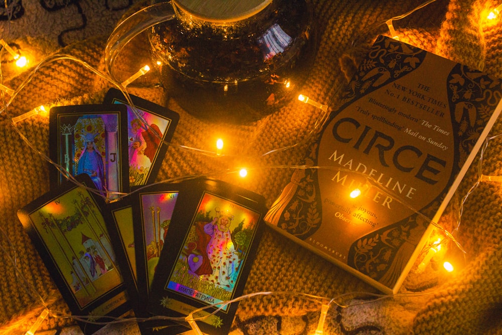 a table topped with cards and candles on top of a blanket