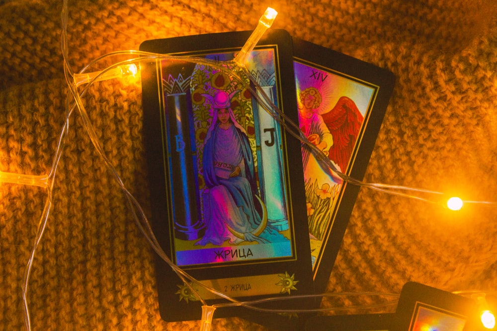 a tarot card surrounded by string lights