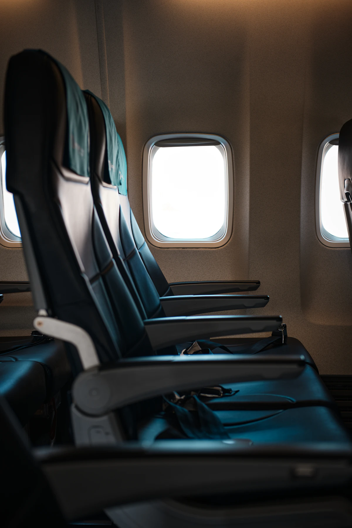 A row of empty seats inside an airplane cabin