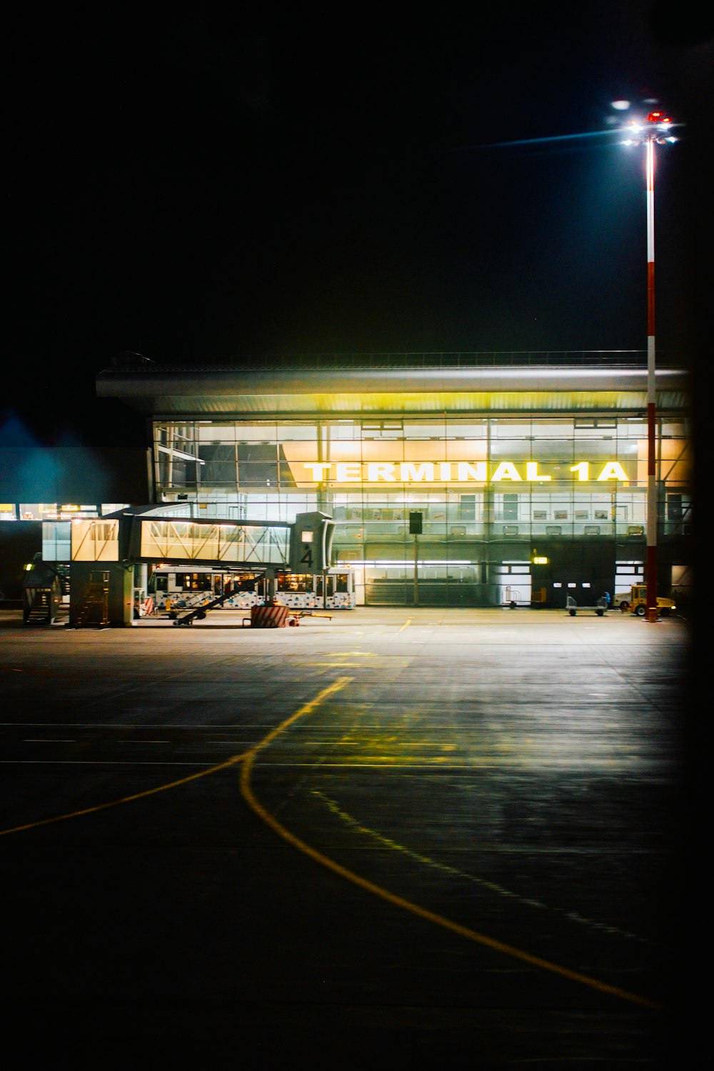 an airport terminal lit up at night time