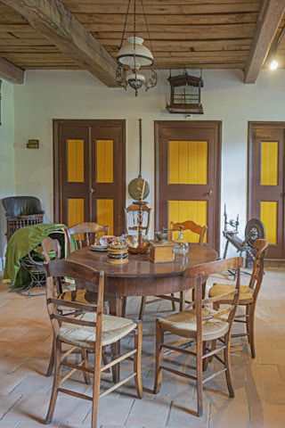 A cozy farmhouse-style staged dining area featuring rustic wooden accents.