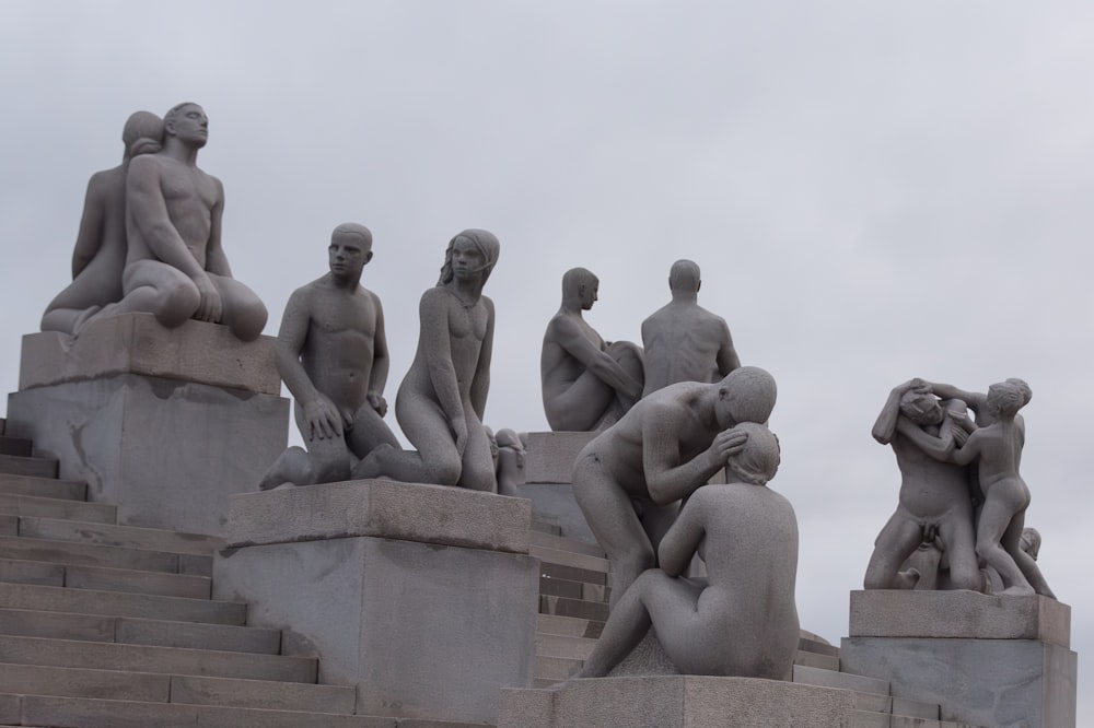 a group of statues sitting on top of cement steps