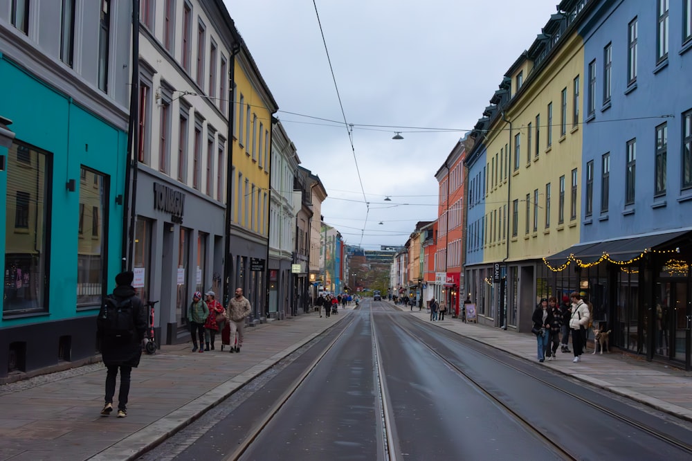 a street lined with buildings and people walking down it