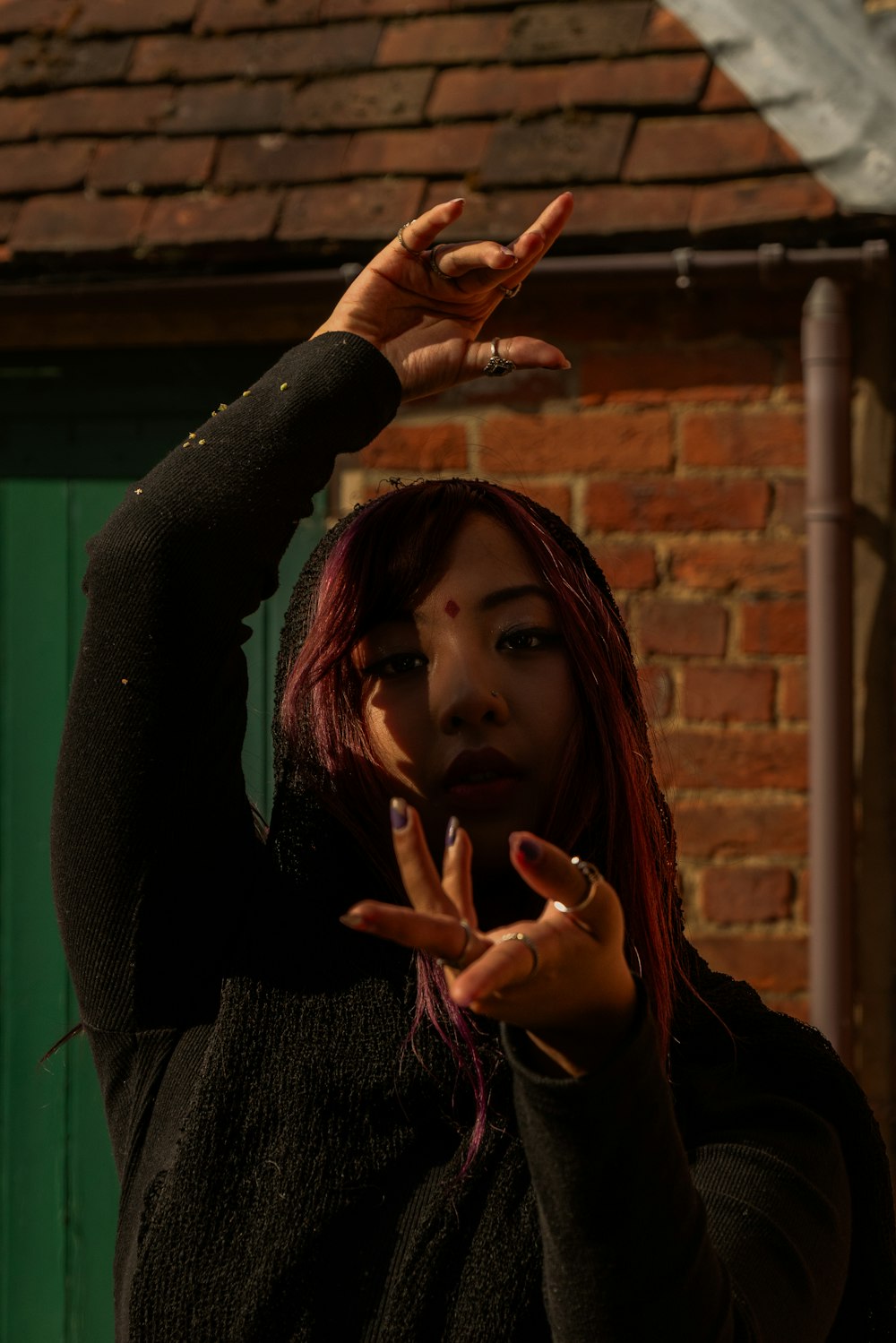 a woman making a peace sign with her hands