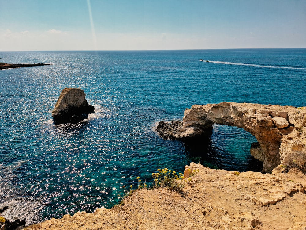 a body of water with a bridge and a boat in the distance