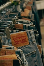 a row of jeans that are sitting on a rack