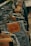 A close-up view of several pairs of Levi Strauss & Co. jeans hanging on metal hangers in a store. The focus is on the leather brand labels which are prominently displayed on the back of the jeans, with the classic Levi's logo and product information.