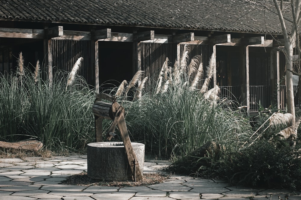 a wooden bench sitting in front of a building