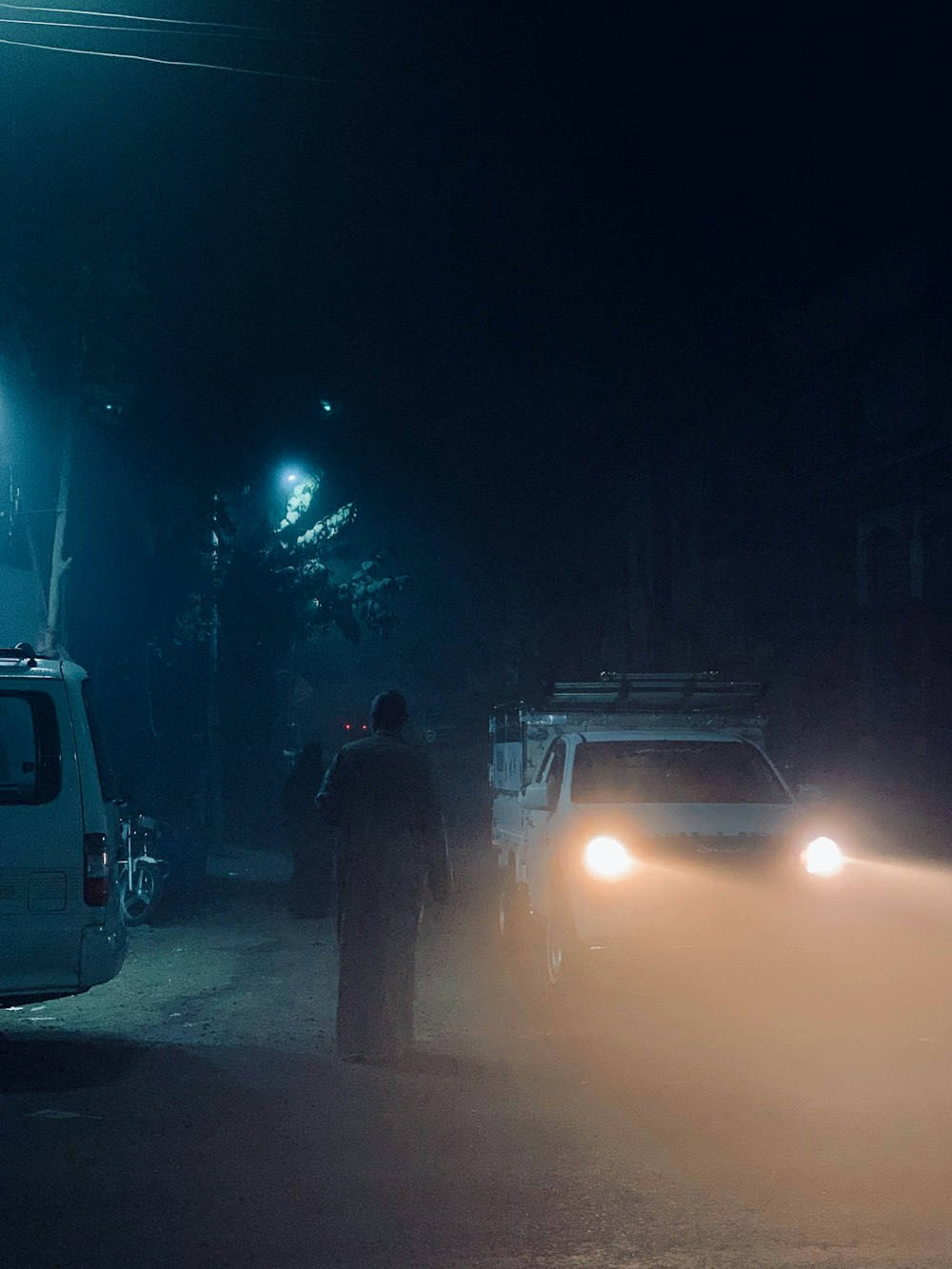 a man standing next to a white van on a street