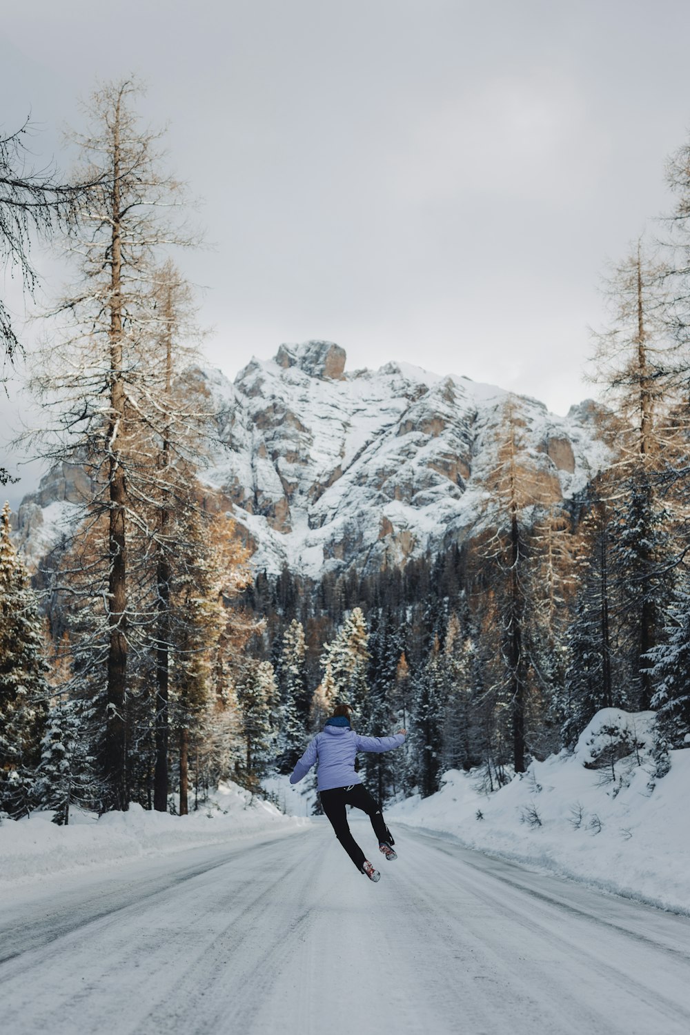 a person is skiing down a snowy road