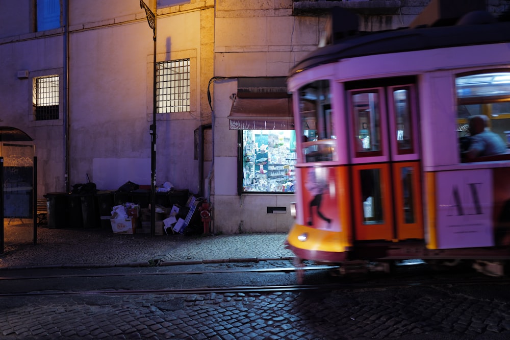 a trolley car on a city street at night