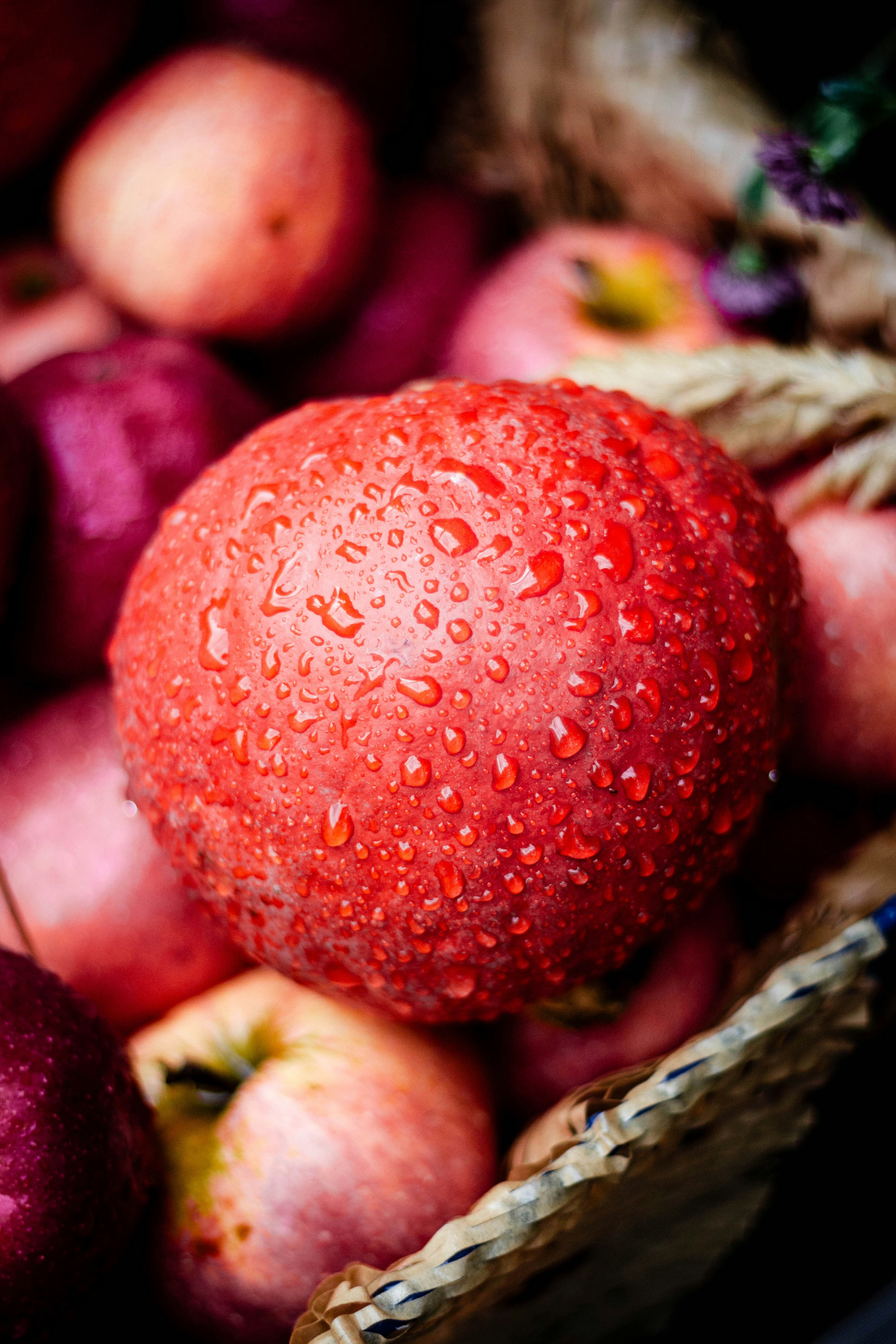 a basket filled with lots of red apples