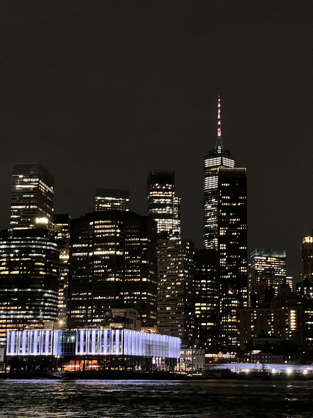 a city skyline at night with the lights on