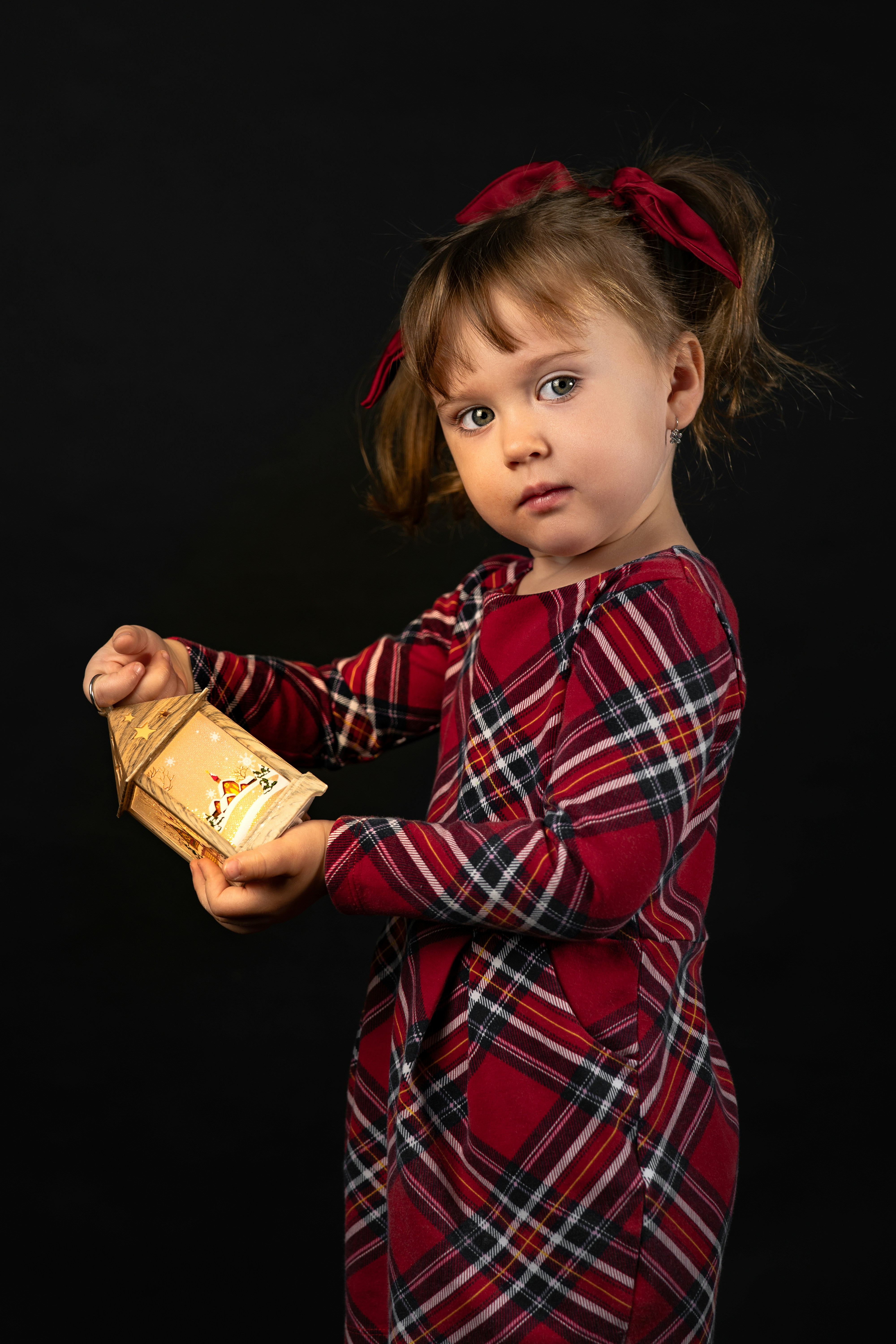 A little girl in a red dress holding a box photo – Free Christmas ...