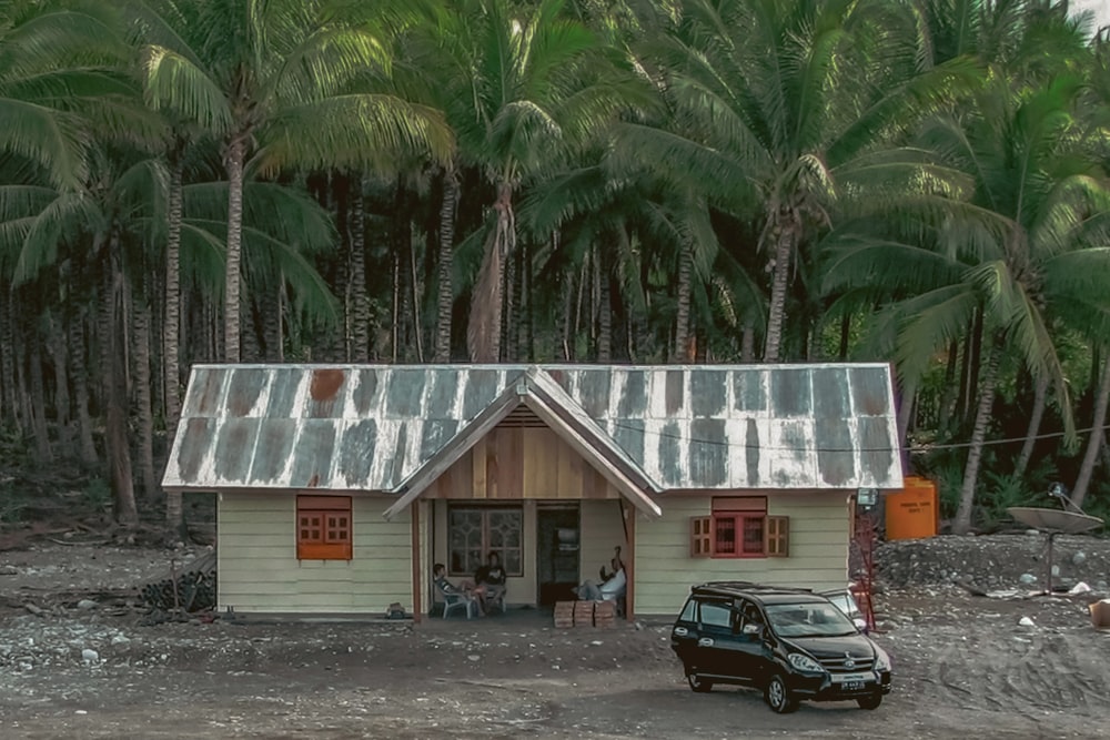 a small house with a car parked in front of it