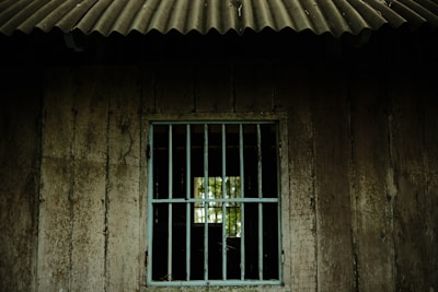 a window with bars on the side of a building