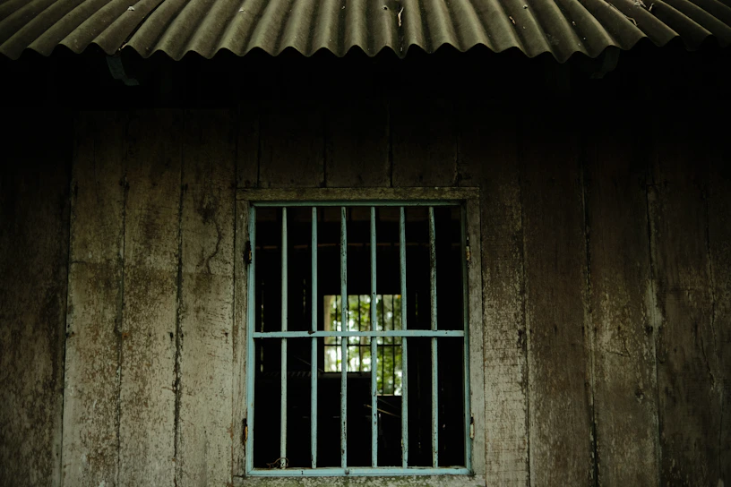 a window with bars on the side of a building