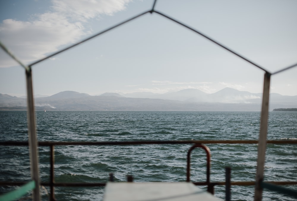 a view of a body of water through a fence