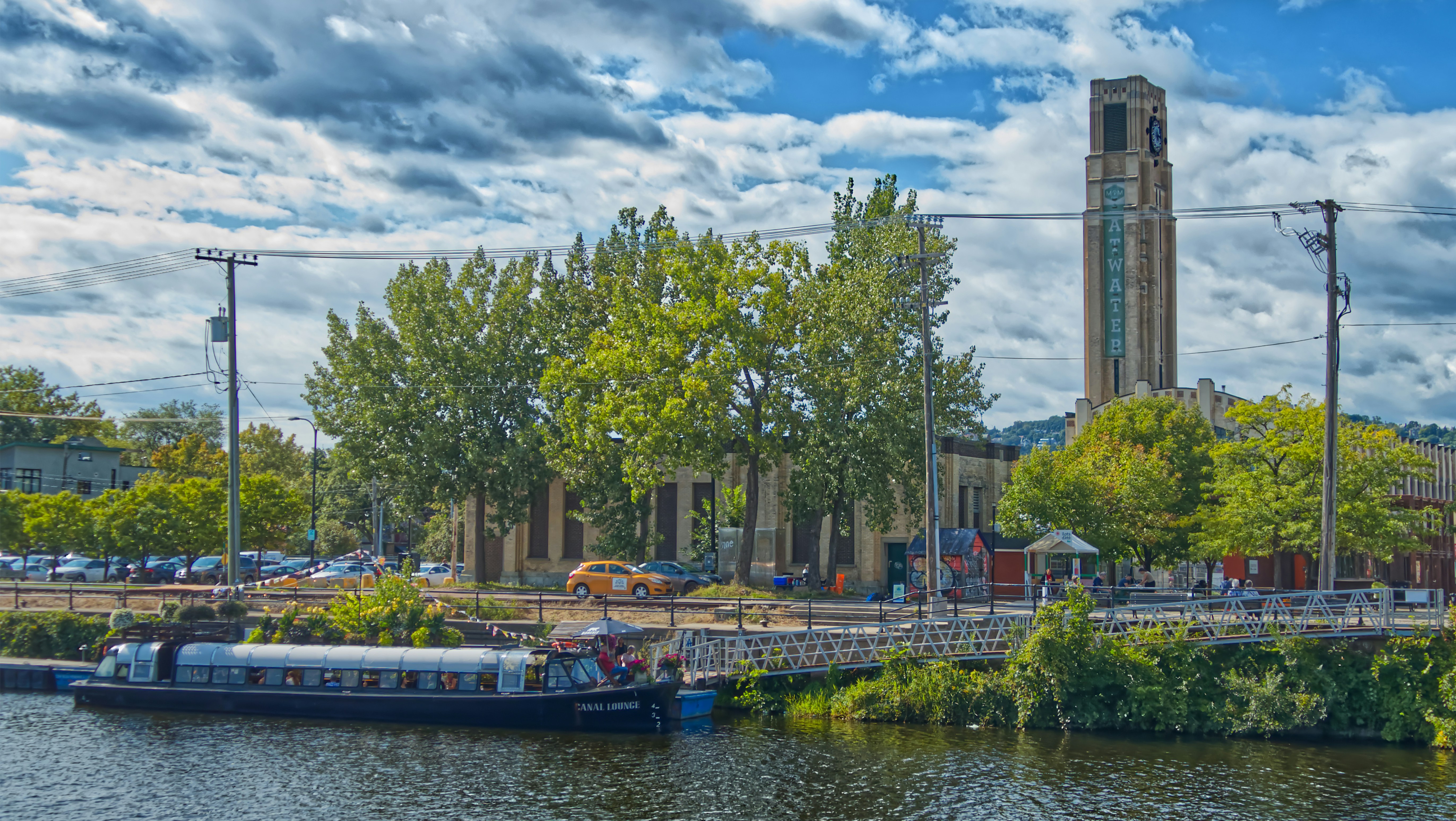 a boat on a river in front of a building with a clock tower