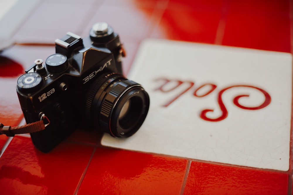 a camera sitting on top of a red tiled floor