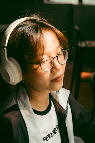 A peaceful scene of a person relaxing with headphones in a cozy, softly lit room.