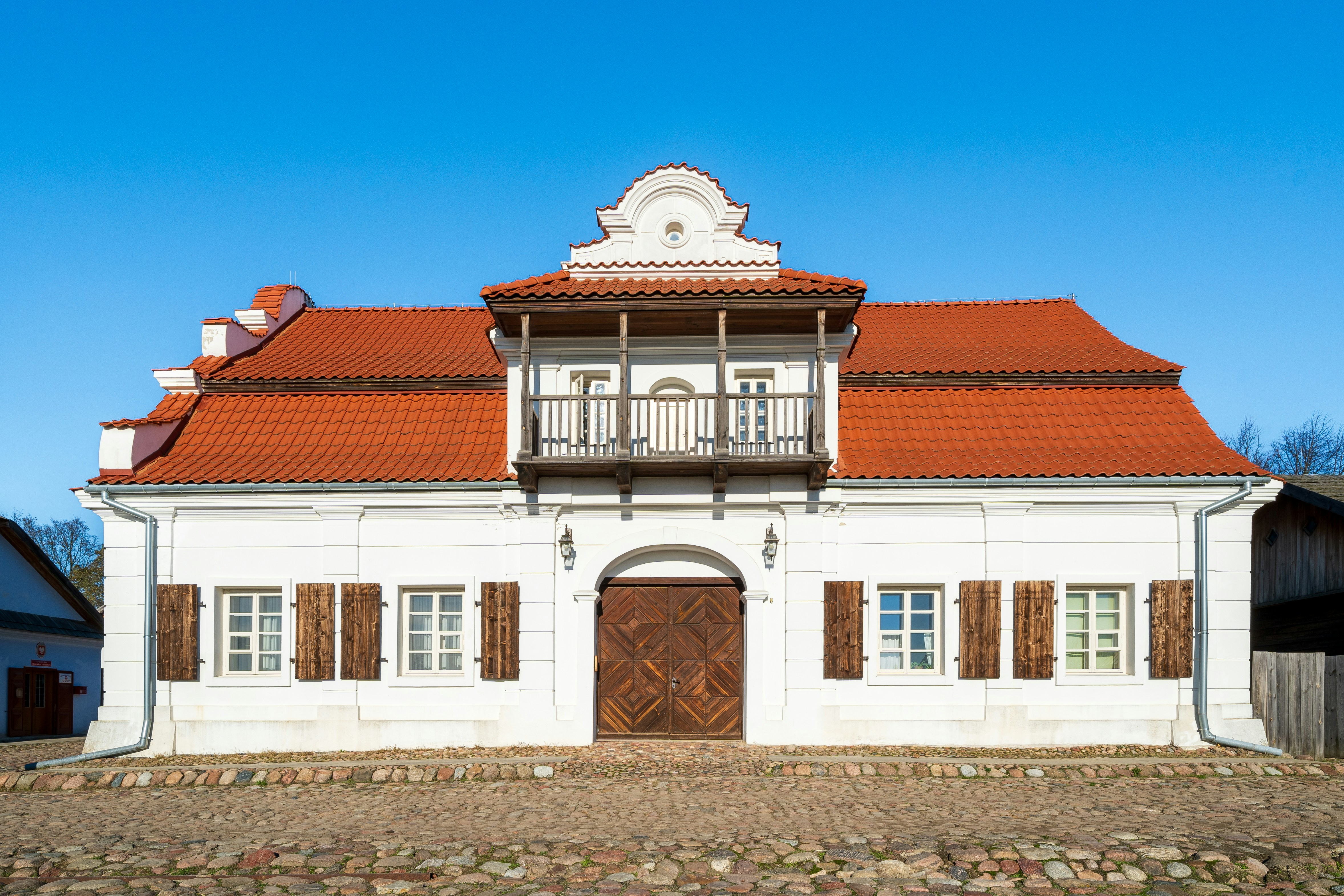 a large white building with a red roof