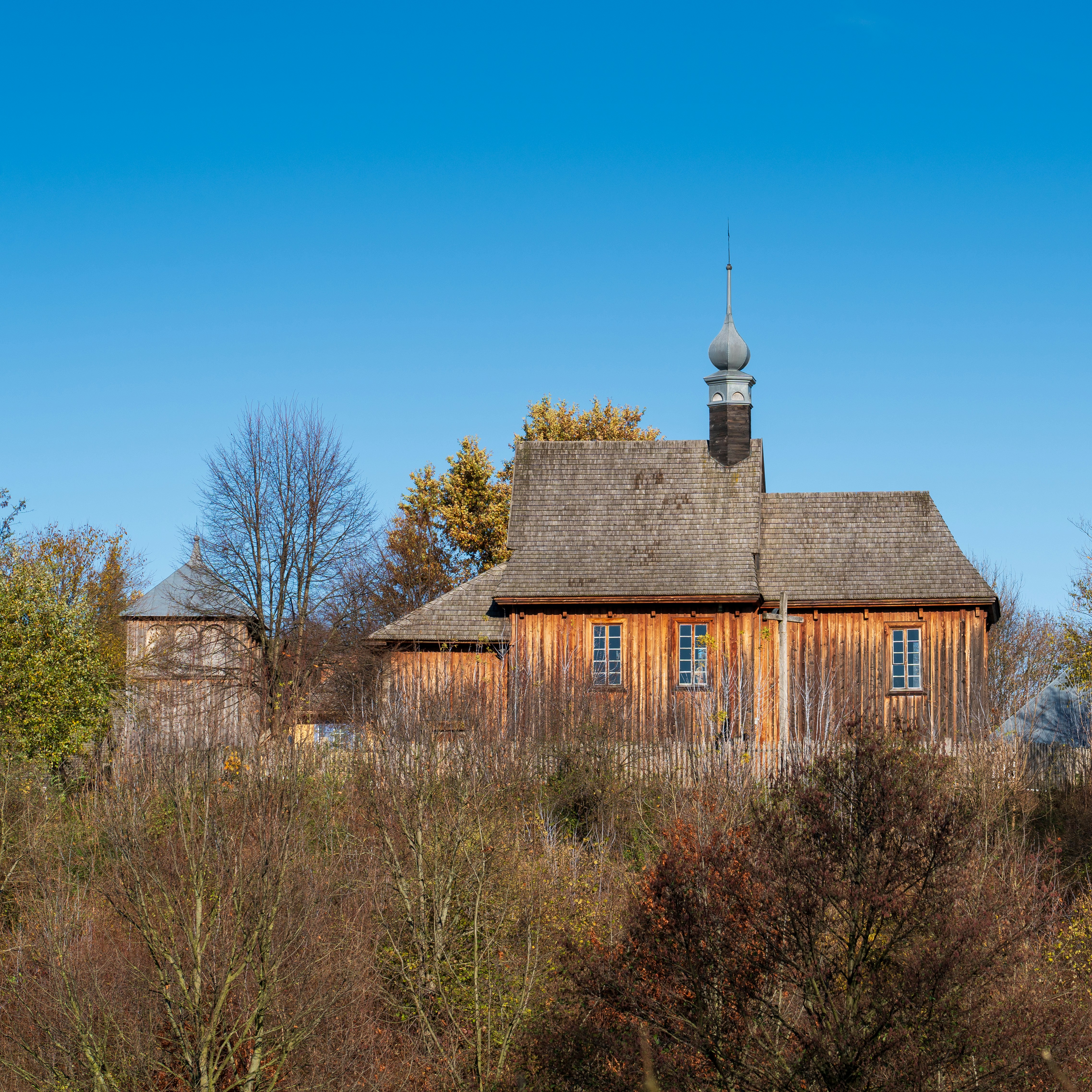 a wooden building with a steeple on top of it