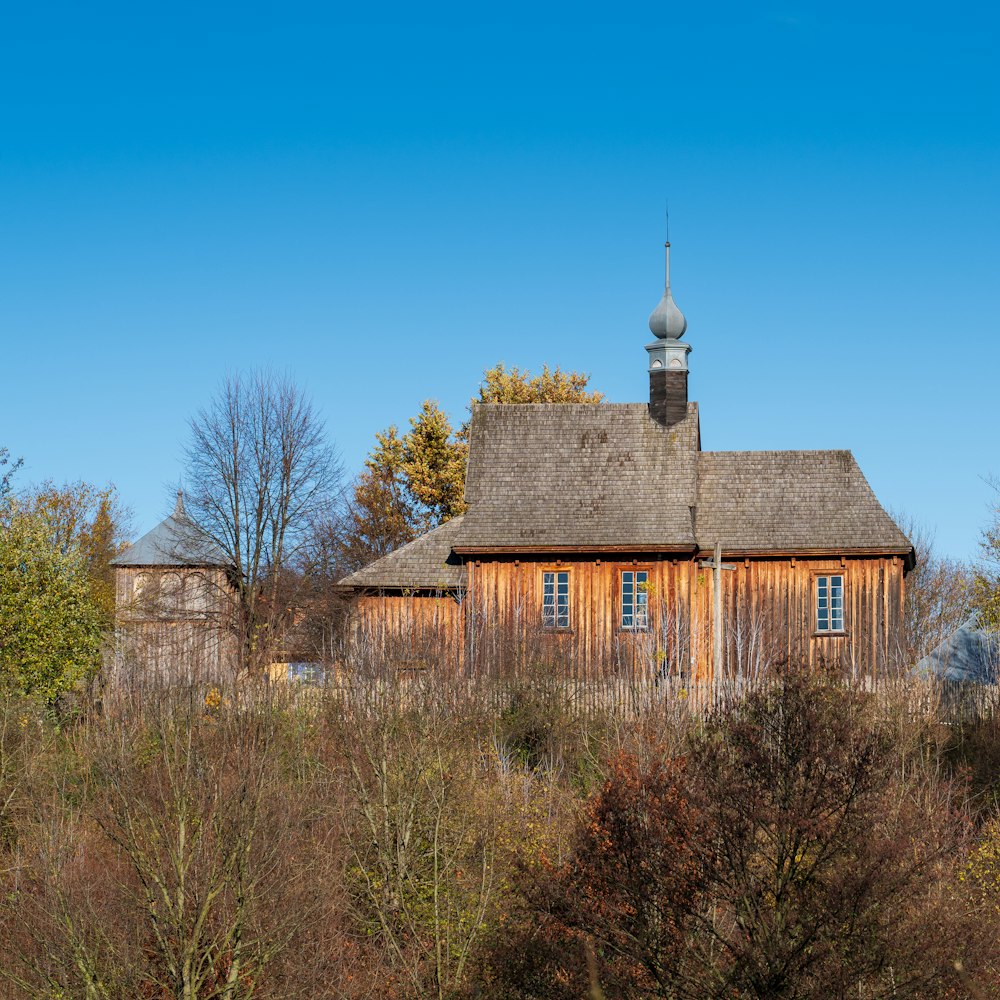 a wooden building with a steeple on top of it