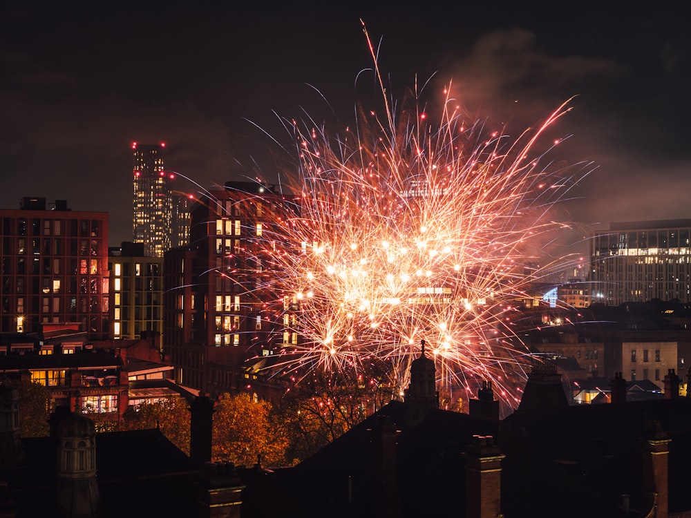 a fireworks display in the night sky over a city