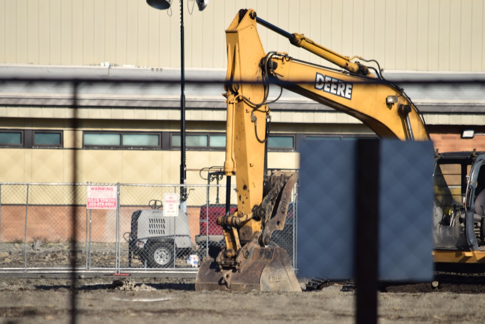 a large yellow bulldozer sitting on top of a dirt field