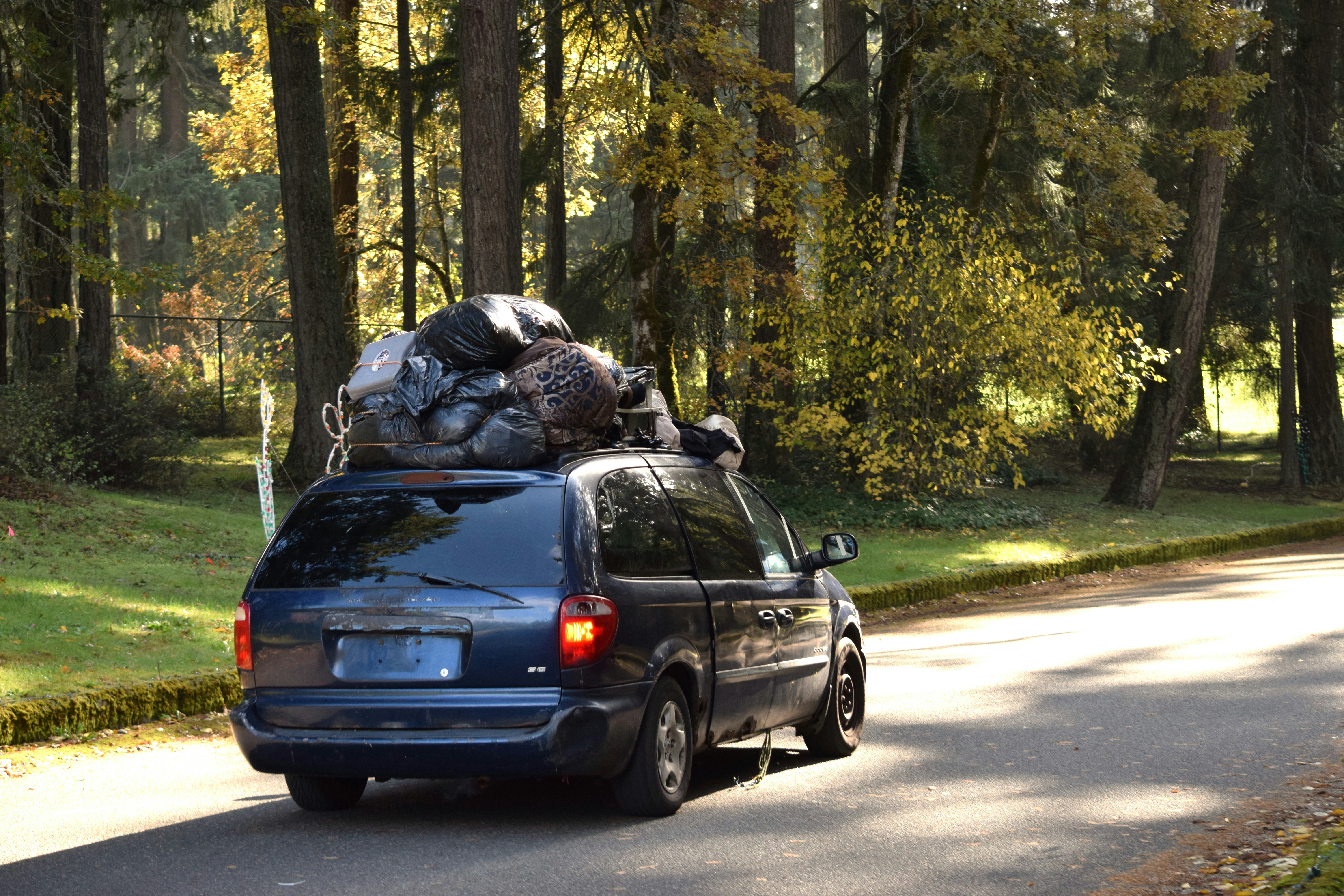Family loading luggage into the back of a Volvo SUV before a road trip