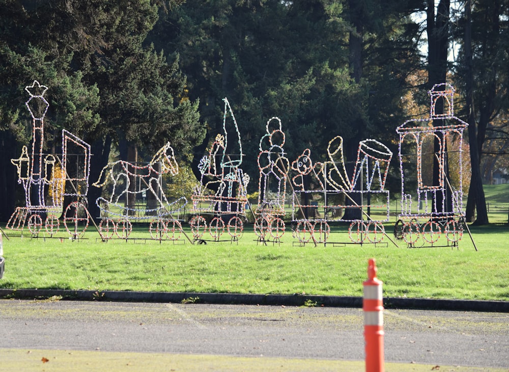 a group of metal sculptures in the middle of a park