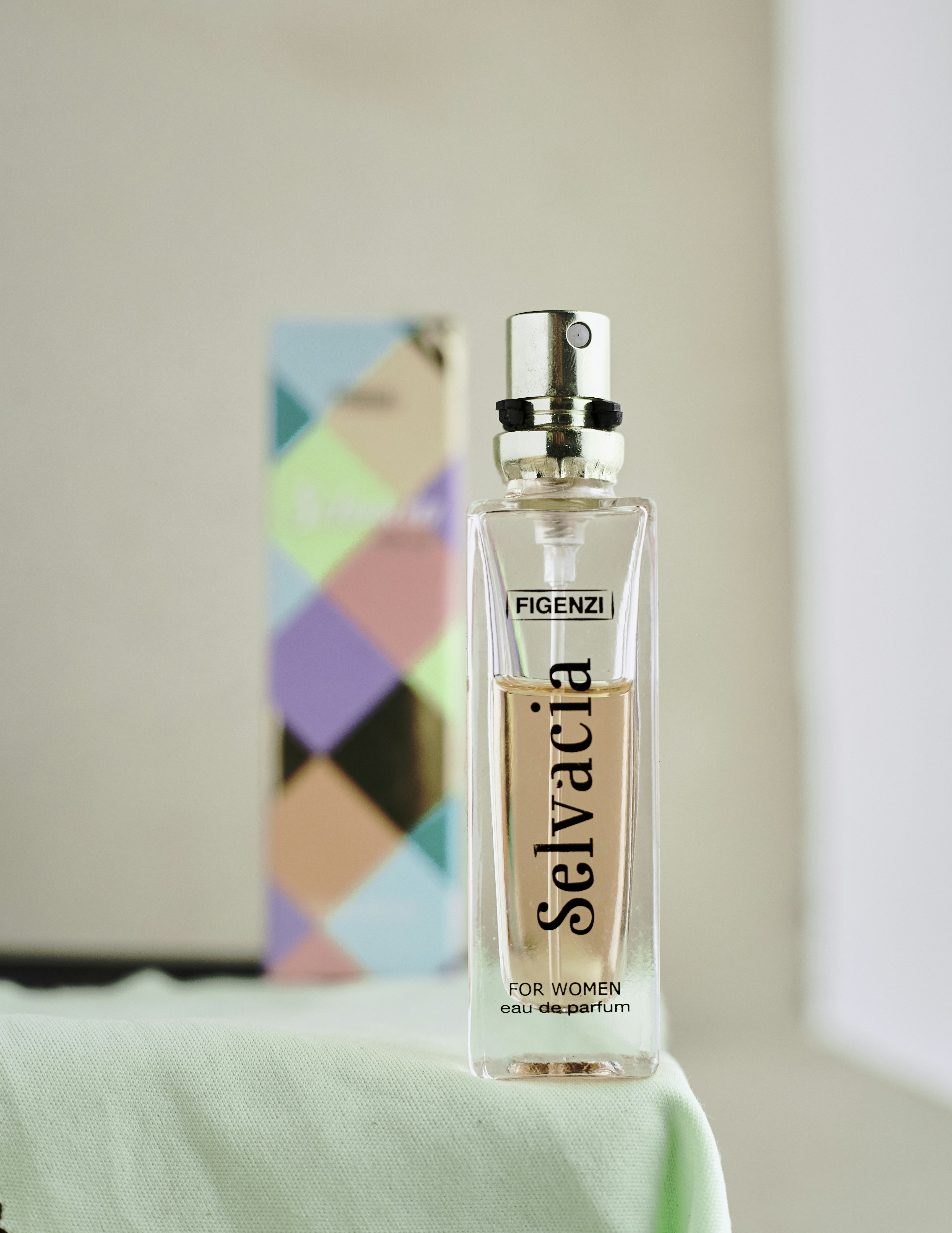 a bottle of perfume sitting on top of a table