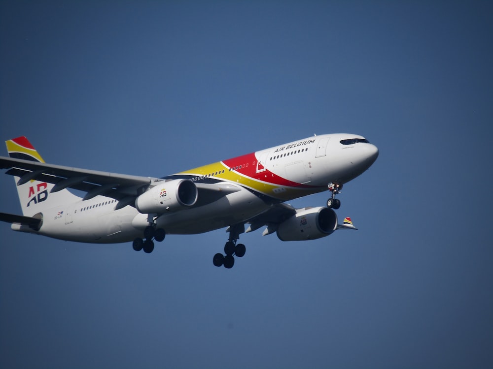 a large jetliner flying through a blue sky