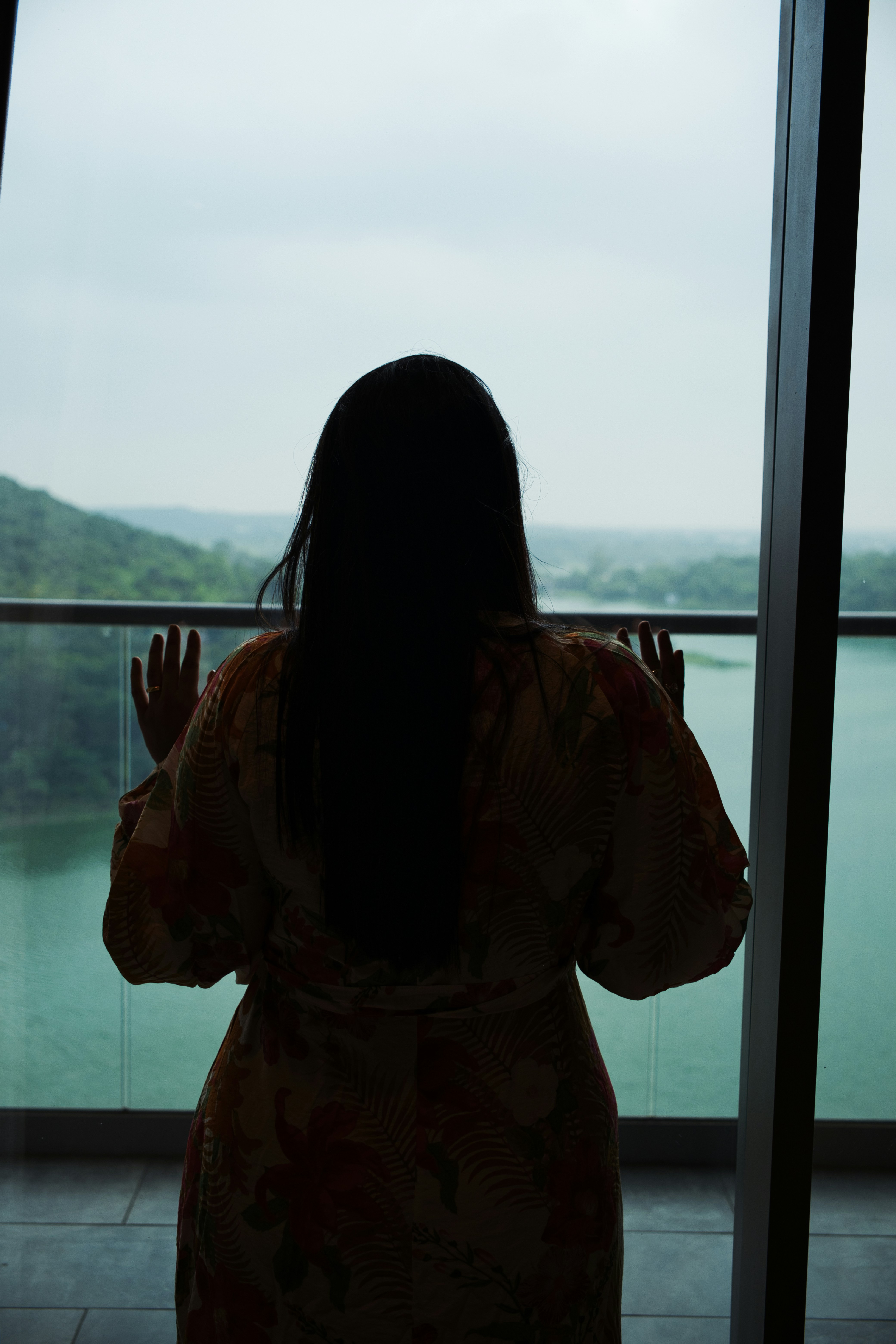 a woman standing in front of a window