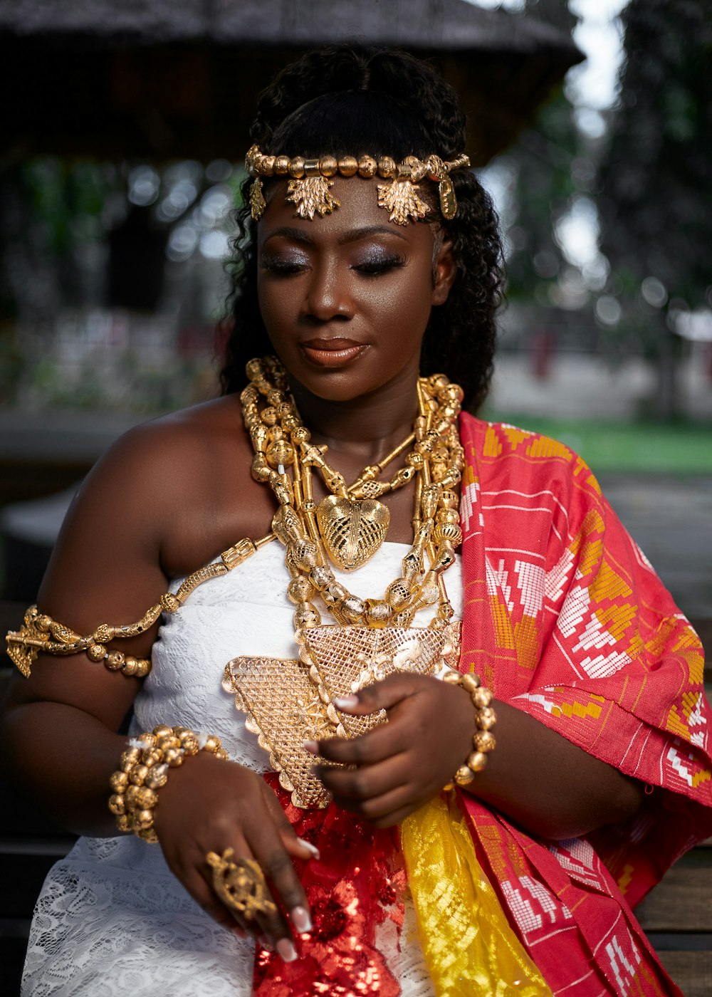 a woman in a white dress and gold jewelry