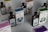 Several bottles and boxes of a product labeled 'UMbra' are arranged on a table. Each box and bottle features distinct artwork and numbers, with illustrations of various animals in different colors. The colors of the packaging are predominantly earthy and muted, with shades of blue, green, and brown. The boxes and bottles appear sleek and are likely part of a set or collection.