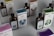 Several bottles and boxes of a product labeled 'UMbra' are arranged on a table. Each box and bottle features distinct artwork and numbers, with illustrations of various animals in different colors. The colors of the packaging are predominantly earthy and muted, with shades of blue, green, and brown. The boxes and bottles appear sleek and are likely part of a set or collection.