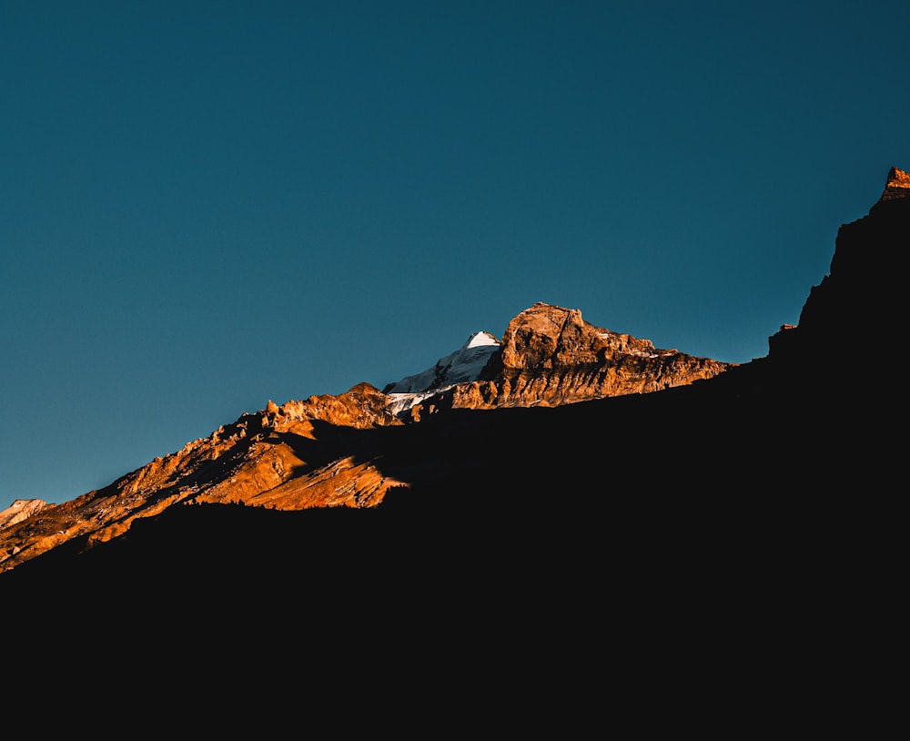 a view of the top of a mountain with a sky background
