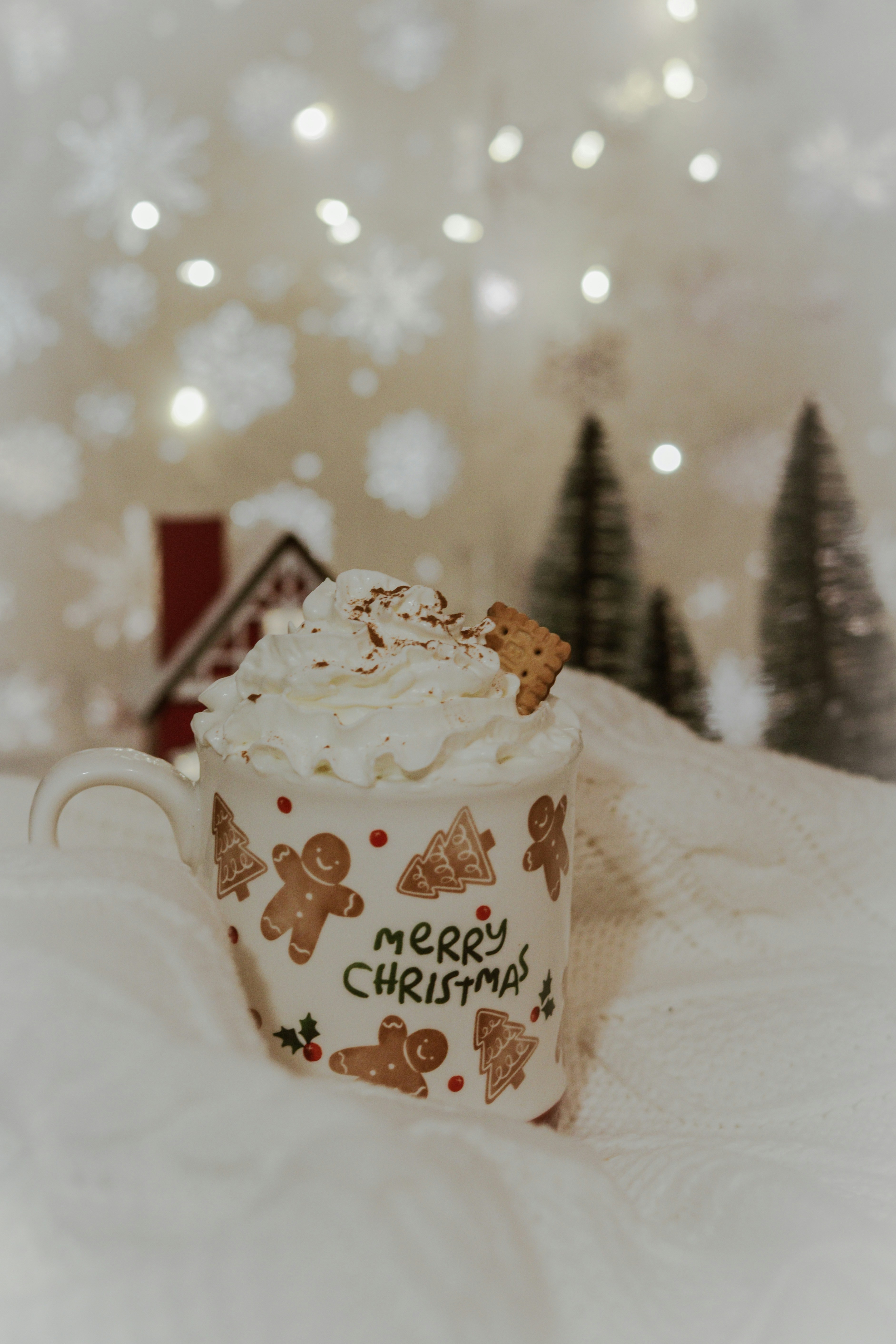 a cup of coffee sitting on top of a white blanket