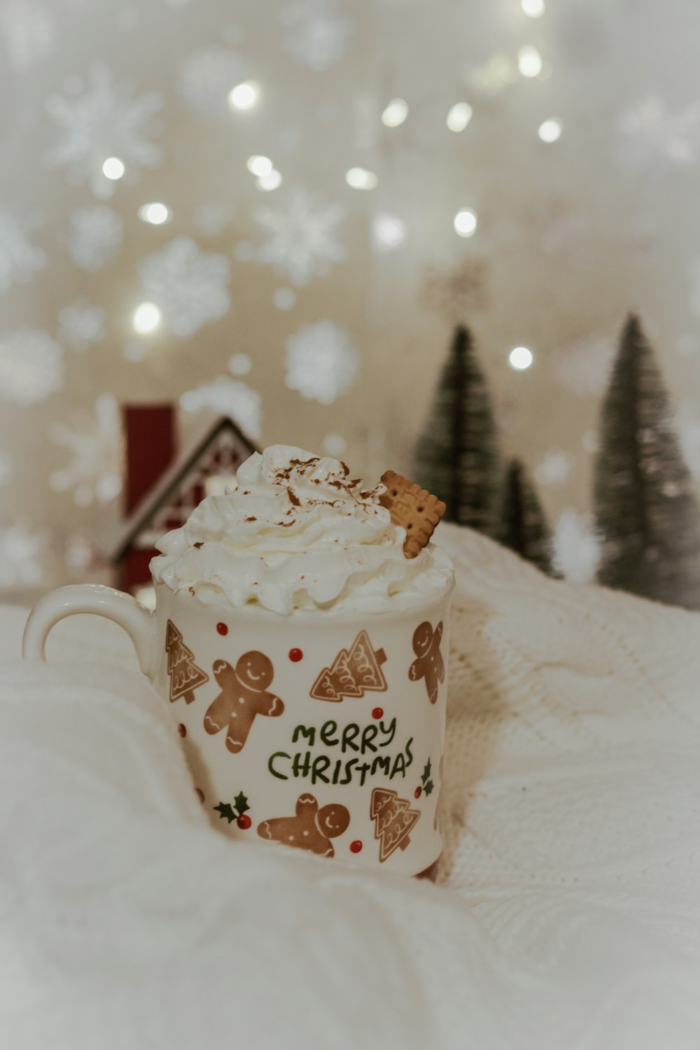 a cup of coffee sitting on top of a white blanket